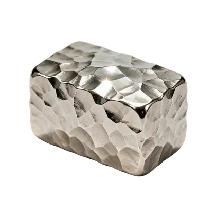 A polished chrome billet covered in coarse hammer facets